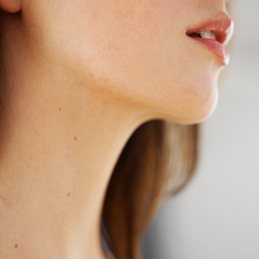 Close-up of a woman's chin and neck