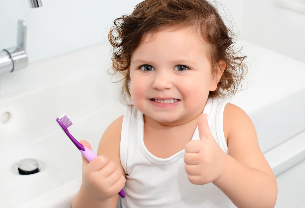 Cute girl brushing her teeth.